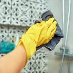 Woman cleaning bathroom cabine